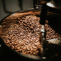 Freshly roasted coffee beans in a metal container for Turkish Coffee Subscription.